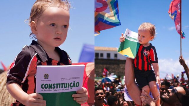Criança de 1 ano viraliza ao segurar a Constituição em ato pró-Lula no Farol da Barra, em Salvador