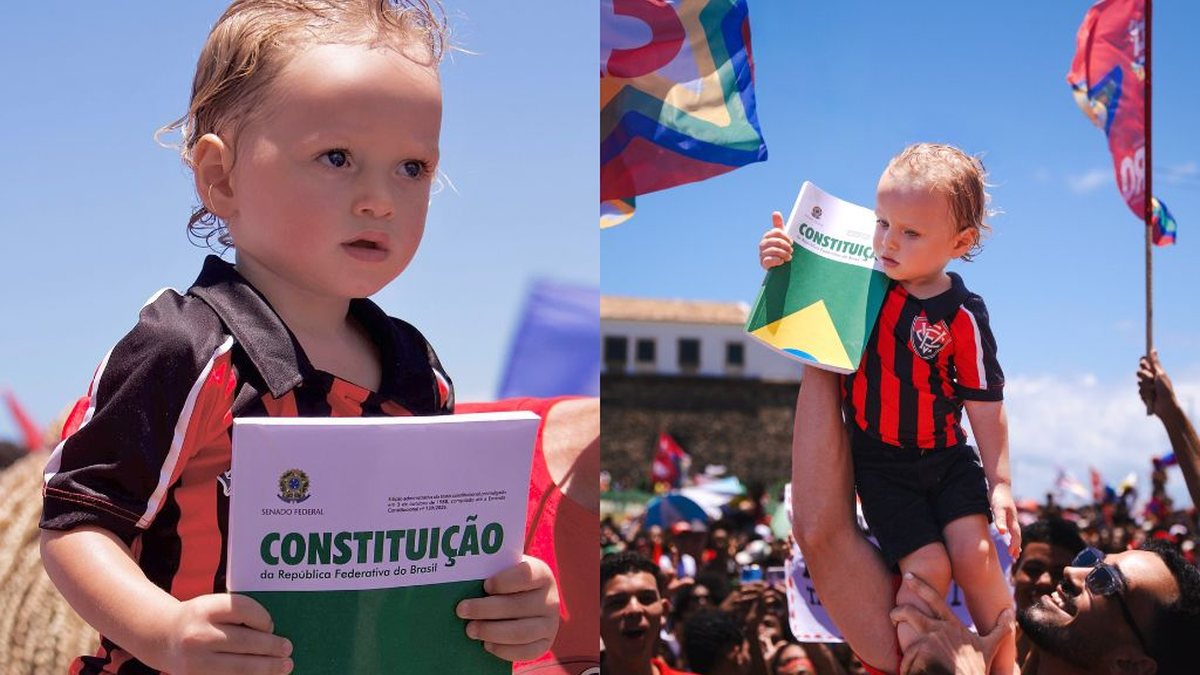 Criança de 1 ano viraliza ao segurar a Constituição em ato pró-Lula no Farol da Barra, em Salvador